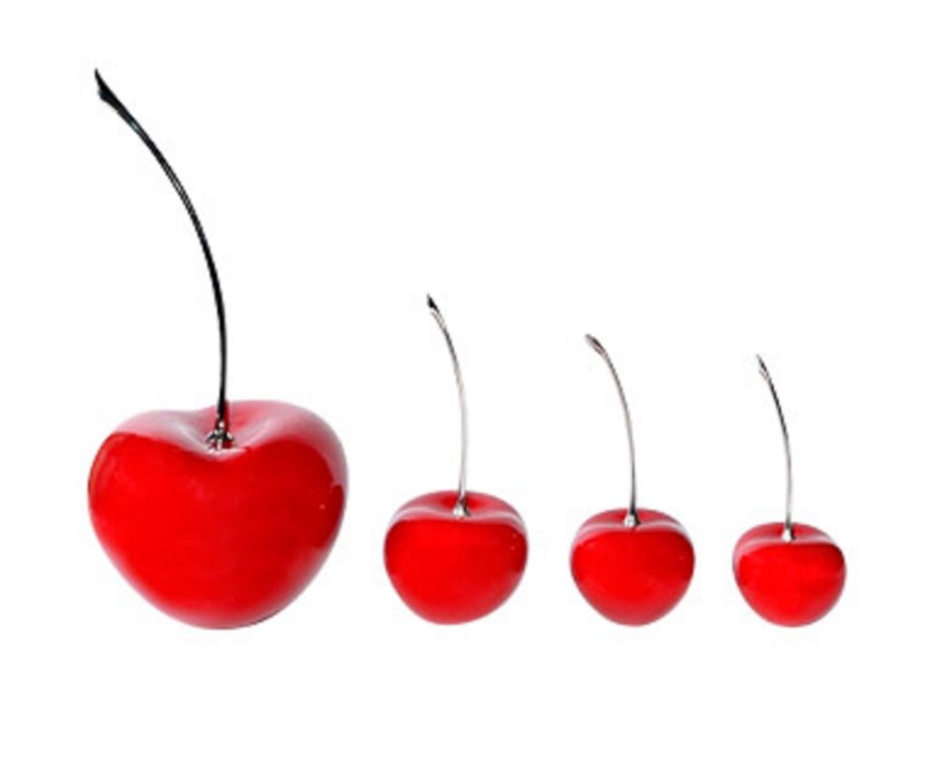 A group of handmade red, ceramic cherries, representing several decorative items for entertaining and interior design.