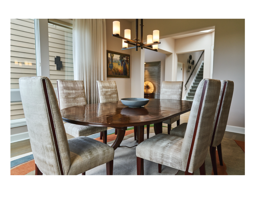 Luxury interior design for a home in Tiburon, California, in the San Francisco Bay Area, including custom designed and upholstered furniture by Ruth Livingston Designs. 

The room includes custom designed and upholstered dining chairs, a luxury, wood dining table, and light fixture.